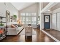 Open-concept living room with high ceilings, hardwood floors, and bright natural light at 19131 E Garden Pl, Centennial, CO 80015