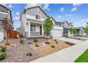 A beautiful two-story home with a two-car garage surrounded by landscaping rocks at 1368 Orchard St, Brighton, CO 80601