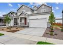 Attractive home with a concrete driveway, two-car garage, and manicured front yard at 1368 Orchard St, Brighton, CO 80601