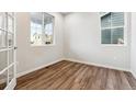 Bright room with hardwood floors and large windows offering plenty of natural light at 1368 Orchard St, Brighton, CO 80601