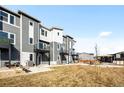 Townhome backyard includes a patio and shared outdoor space with benches and picnic tables at 2672 W 68Th Ave, Denver, CO 80221