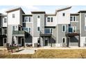 Modern townhome exterior featuring gray siding and private balconies at 2672 W 68Th Ave, Denver, CO 80221