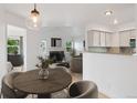 Open concept dining area leads to living room and kitchen with great natural lighting at 11 W Ellsworth Ave # 22, Denver, CO 80223