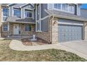 Lovely home exterior featuring a three car garage, brick accents, and a well maintained walkway at 6493 W 98Th Ct, Westminster, CO 80021