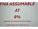 Sign stating that the mortgage is FHA assumable at a rate of 6% at 12400 Village Circle, Brighton, CO at 12400 Village Cir, Brighton, CO 80603