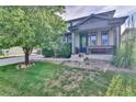 Charming front porch with lush landscaping offering a welcoming entrance to the home at 12400 Village Cir, Brighton, CO 80603