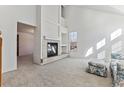Spacious living room featuring a fireplace and large windows at 6415 Trailhead Rd, Highlands Ranch, CO 80130