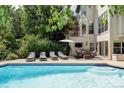Beautiful outdoor pool area featuring lounge chairs, an umbrella, and a seating area at 9311 E Star Hill Trl, Lone Tree, CO 80124