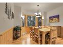 Rustic dining room featuring wood furnishings, wainscoting, and a nature-inspired decor at 29266 S Sunset Trl, Conifer, CO 80433
