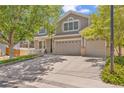 Two-story home with lush front yard, mature shade trees, and a spacious driveway leading to the garage at 2938 S Zeno Way, Aurora, CO 80013