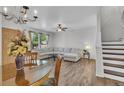 Open living room with plush seating, elegant lighting, and seamless flow to the dining area at 9758 Laredo St # 35B, Commerce City, CO 80022
