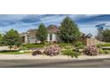 Charming home exterior featuring beautiful landscaping and a well-maintained front yard at 4495 Windmill Dr, Brighton, CO 80601