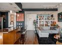 Open concept living room featuring modern design elements, stylish furniture, and decorative art at 2460 W 29Th Ave # 104, Denver, CO 80211