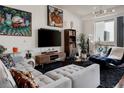 Bright living room showcasing unique furniture, stylish décor, and expansive windows at 2460 W 29Th Ave # 104, Denver, CO 80211
