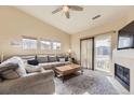 Bright living room with plush seating, a fireplace, and sliding doors to the balcony at 9569 Pearl Cir # 204, Parker, CO 80134