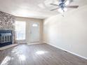 Living room with fireplace and wood-look flooring at 15475 E Louisiana Ave, Aurora, CO 80017