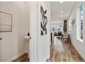 Bright hallway with hardwood floors leads to an open-concept living space at 17848 Gallup St, Broomfield, CO 80023