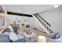 A cozy living room features neutral tones, a decorative fireplace, and a staircase at 1557 S Owens St # 59, Denver, CO 80232