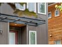 Front entry with porch cover, exterior fixture and wood siding on adjacent home at 4557 Stuart St, Denver, CO 80212