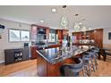 Well-designed kitchen with a large island, granite countertops, stainless steel appliances, and a dining area at 2194 S Braun Way, Lakewood, CO 80228