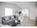 Bright living room with vaulted ceilings, modern decor, and lots of natural light at 3423 W Walsh Pl, Denver, CO 80219