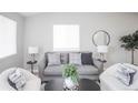 Cozy living room featuring comfortable seating, stylish decor, and lots of light at 3423 W Walsh Pl, Denver, CO 80219