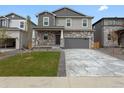 Charming home with stone accents, a well-maintained lawn, and a two-car garage at 553 Homestead Ave, Brighton, CO 80601