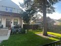 The front yard showcasing a well-manicured lawn, flower beds, and a section of the home's exterior at 1690 Spruce St, Denver, CO 80220
