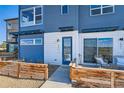 Charming home displaying blue exteriors and a cozy front patio complemented by a wooden fence at 2446 W 167Th Ln, Broomfield, CO 80023