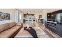 Open-concept living room showcasing kitchen, island with seating, and stylish modern design at 2446 W 167Th Ln, Broomfield, CO 80023