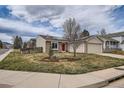 Charming single-story home featuring a brick facade, attached two-car garage, and a well-manicured front yard at 5587 S Simms Way, Littleton, CO 80127
