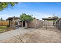 The home's backyard offers an updated storage area, fencing, and shade at 530 S Quitman St, Denver, CO 80219