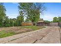 The fenced backyard has mature landscaping, detached storage, and plenty of parking at 530 S Quitman St, Denver, CO 80219