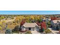 Beautifully landscaped home in a neighborhood surrounded by lush trees and colorful foliage at 5924 S Kittredge St, Centennial, CO 80016