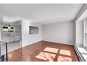 Bright living room featuring hardwood floors, fresh paint, and lots of natural light at 1796 S Yampa Way, Aurora, CO 80017