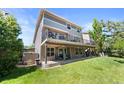 Expansive backyard featuring a multi-level deck, a lush lawn, mature trees, and a beautifully landscaped yard at 9290 Melborne Ct, Parker, CO 80134
