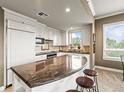 Charming kitchen features white cabinetry, granite countertops, stainless steel appliances, and a breakfast bar with seating at 400 E 3Rd Ave # 305, Denver, CO 80203