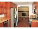 Spacious kitchen with stainless steel appliances, wood floors, granite counters, and lots of cabinet space at 7891 Poplar St, Commerce City, CO 80022