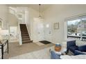 Cozy living room featuring carpet, staircase to the upper level, and lots of natural light at 8510 Bluegrass Cir, Parker, CO 80134