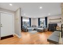 Bright and airy living room featuring hardwood floors, a comfortable gray sectional, and large windows at 3175 Zinnia Ct, Golden, CO 80401