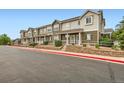 A row of townhouses featuring pleasant exteriors, landscaping, and convenient street access at 14700 E 104Th Ave # 2802, Commerce City, CO 80022