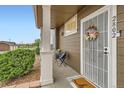 Cozy front porch enhanced with decorative wreath, seating, and a welcoming doormat at 14700 E 104Th Ave # 2802, Commerce City, CO 80022