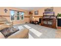 Cozy living room with large windows and entertainment center with tv at 5870 Quail St, Arvada, CO 80004