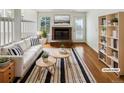 Bright living room with a fireplace, striped rug and modern furniture at 8536 S Upham Way, Littleton, CO 80128