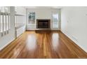 A living room featuring hardwood floors, a fireplace, and natural light at 8536 S Upham Way, Littleton, CO 80128
