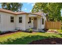 Charming home featuring a manicured lawn, neat landscaping, and a welcoming front porch at 4467 N Umatilla St, Denver, CO 80211