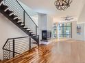 Spacious living room featuring hardwood floors, fireplace, and large windows at 2345 Walnut St # 24, Denver, CO 80205