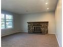 Spacious living room with neutral carpet and a stone fireplace at 2617 S Cimarron St, Aurora, CO 80014
