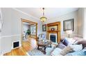 Cozy living room with hardwood floors, a decorative fireplace, vintage lighting and a stylish area rug at 2227 N Ogden St, Denver, CO 80205