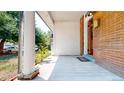Inviting porch with white columns, a brick wall, a light fixture and space for decorative plants at 2227 N Ogden St, Denver, CO 80205